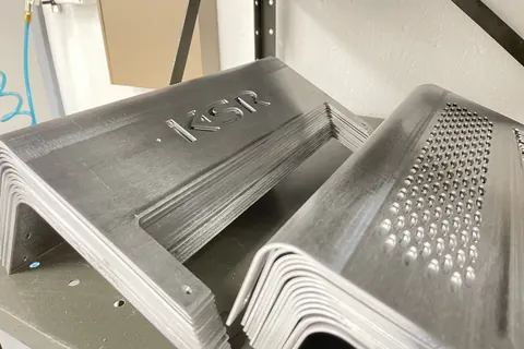 Stack of formed aluminum amplifier hoods with perforated vents