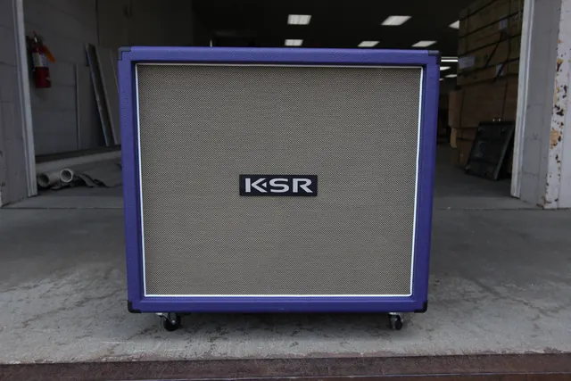 Purple 4&times;12 speaker cabinet on the loading dock