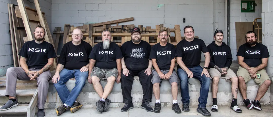 The shop crew sitting together on the loading dock